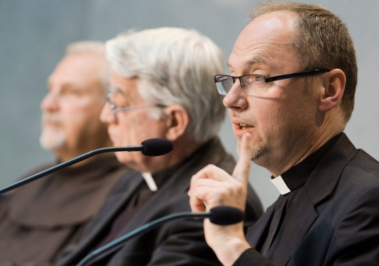 Monsignor Slawomir Oder, postulator of late Pope John Paul II, right, speaks during a press conference in Vatican City, Tuesday, April 22, 2014. Polish priest Oder, who has spearheaded the case to make Pope John Paul II a saint, says there is no documentation that he had any 