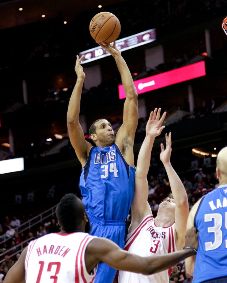   Dallas Mavericks' Brandan Wright (34) shoots over Houston Rockets' Omer Asik (3) during the first half of an NBA basketball game, Saturday, Dec. 8, 2012, in Houston. (AP Photo/Bob Levey)  