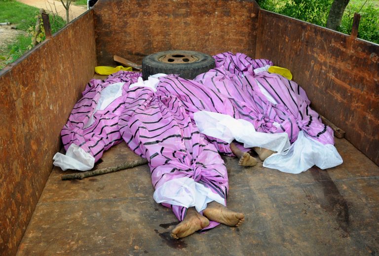 The bodies of women, who have been accused of practicing witchcraft, are placed in a truck in Kinjia village in Jharkhand state, India, Saturday, Aug. 8, 2015. Dozens of villagers in eastern India beat to death five women Saturday, accusing them of practicing witchcraft and blaming them for a series of misfortunes in the village, police said. (AP Photo)