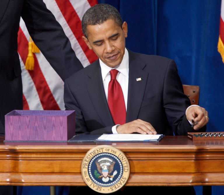FILE This Feb. 17, 2009 file photo shows President Barack Obama picking up the first pen to sign the economic stimulus bill during a ceremony in the Museum of Nature and Science in Denver. The White House says a costly spending bill President Barack Obama signed into law five years ago Monday was good for the economy and helped the U.S. avoid another Great Depression. (AP Photo/David Zalubowski, File)