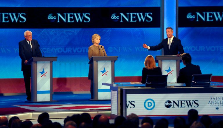 Martin O'Malley, right, speaks alongside Bernie Sanders, left, and Hillary Clinton, center, during a Democratic presidential primary debate Saturday, Dec. 19, 2015, at Saint Anselm College in Manchester, N.H. (AP Photo/Jim Cole)