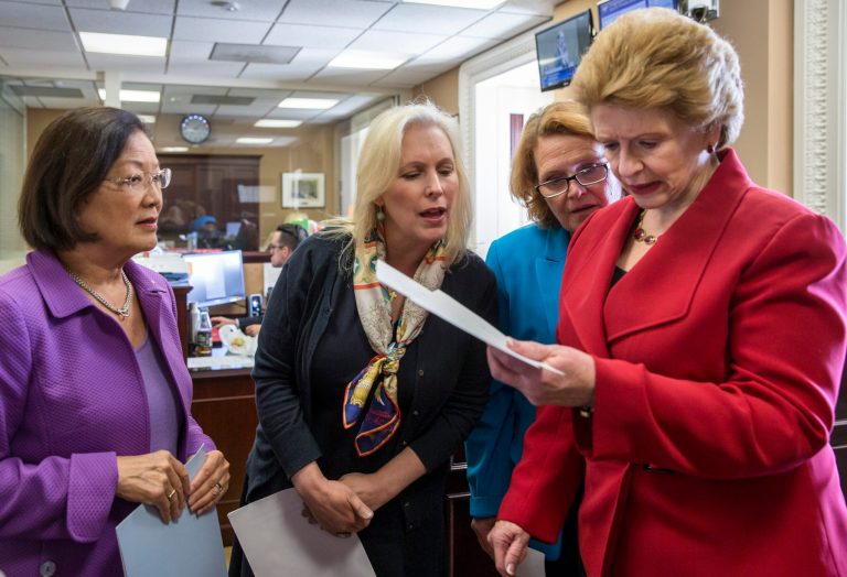 From left, Sen. Mazie Hirono, D-Hawaii, Sen. Kirsten Gillibrand, D-N.Y., Sen. Heidi Heitkamp, D-N.D., and Sen. Debbie Stabenow, D-Mich., confer before speaking with reporters on Capitol Hill on June 29. (AP Photo/J. Scott Applewhite)