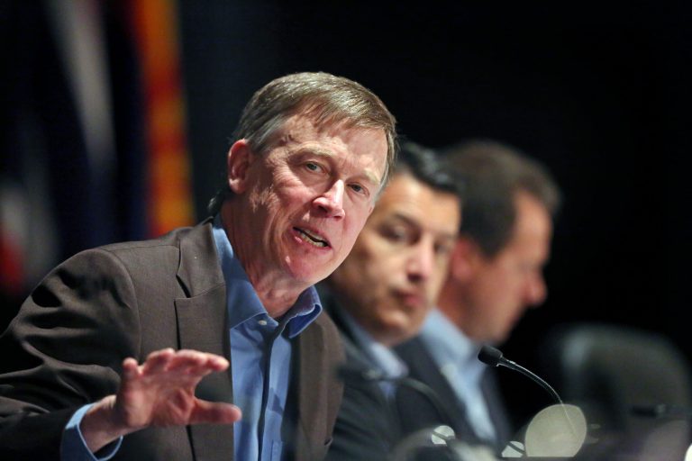 Colo. Governor John Hickenlooper, left, gestures during a roundtable discussion titled The Impacts of Major Western Oil and Gas Finds: Meeting Challenges and Capturing Opportunities, during the annual Western Governors' Association Meeting, at the Broadmoor Hotel in Colorado Springs, Tuesday, June 10, 2014.   The head of the Environmental Protection Agency promoted proposed clean power plant rules to Western governors Tuesday, framing the plan as a way to deal with destructive wildfires and floods that have ravaged the region in recent years. (AP Photo/Brennan Linsley)