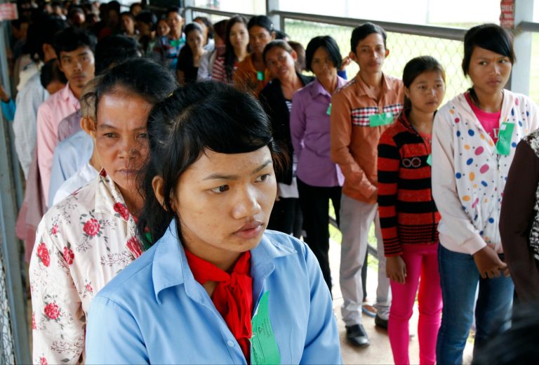 In this July 30, 2014 photo, Cambodians line up at a court entrance before a hearing to prepare for the genocide trial of two surviving leaders Khieu Samphan and Noun Chea, at the U.N.-backed war crimes tribunal in Phnom Penh, Cambodia. A U.N.-assisted court on Thursday, Aug. 7, 2014 will deliver its verdicts in a case against the two most senior surviving leaders of Cambodia's Khmer Rouge, charged with crimes against humanity. (AP Photo/Heng Sinith)