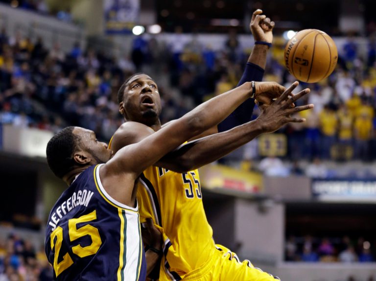   Utah Jazz center Al Jefferson (25) fouls Indiana Pacers center Roy Hibbert in the first half of an NBA basketball game in Indianapolis, Wednesday, Dec. 19, 2012. (AP Photo/Michael Conroy)  