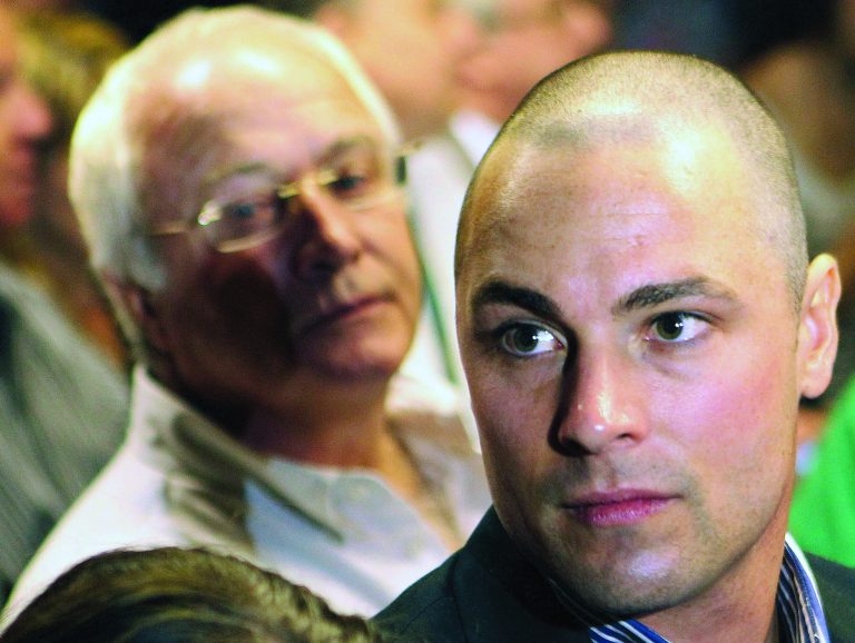 FILE - In this Feb. 19, 2013 file photo, Carl Pistorius, right, and Henke Pistorius, the brother and father of Olympic athlete Oscar Pistorius, charged with the shooting death of his girlfriend attend Oscar's bail hearing at the magistrate court in Pretoria, South Africa. A report by a local television station on Sunday, Feb. 24, 2013, revealed that Carl Pistorius is facing a charge of culpable homicide for the death of a woman knocked down on her motorbike in 2010. (AP Photo/Themba Hadebe, File)