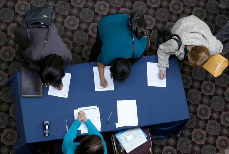In this Wednesday, Jan. 22, 2014, photo, job seekers sign in before meeting prospective employers during a career fair at a hotel in Dallas. The Labor Department releases weekly jobless claims, on Thursday, Jan. 23, 2014. (AP Photo/LM Otero)