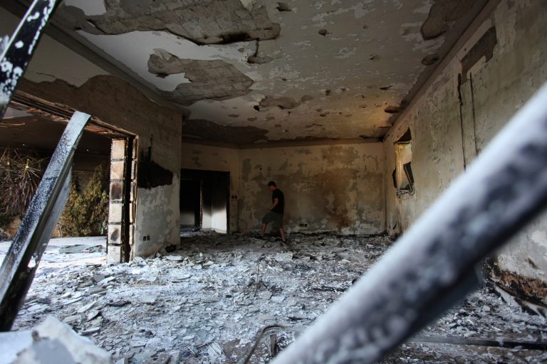 This Sept. 13, 2012 file photo shows a man walking in the rubble of the damaged U.S. consulate, after an attack that killed four Americans, including Ambassador Christopher Stevens on the night of Tuesday, Sept. 11, 2012, in Benghazi, Libya. (AP photo/Mohammad Hannon, File)
