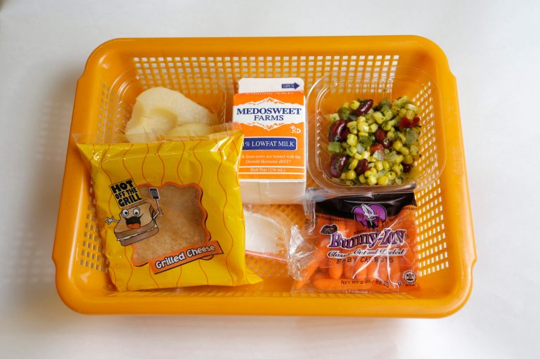 A school lunch featuring a grilled cheese sandwich on whole grain bread served with a southwestern-style corn salad, fresh carrots and either canned pears or apple sauce is shown Monday, May 5, 2014, at Mirror Lake Elementary School in Federal Way, Wash., south of Seattle. (AP Photo/Ted S. Warren)