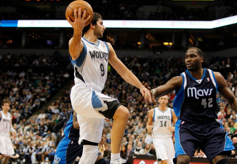   Minnesota Timberwolves point guard Ricky Rubio (9), of Spain, passes the ball around Dallas Mavericks power forward Elton Brand (42) during the first half on an NBA basketball game on Saturday, Dec. 15, 2012, in Minneapolis. Rubio was making his season debut after recovering from surgery on his left knee. (AP Photo/Genevieve Ross)  