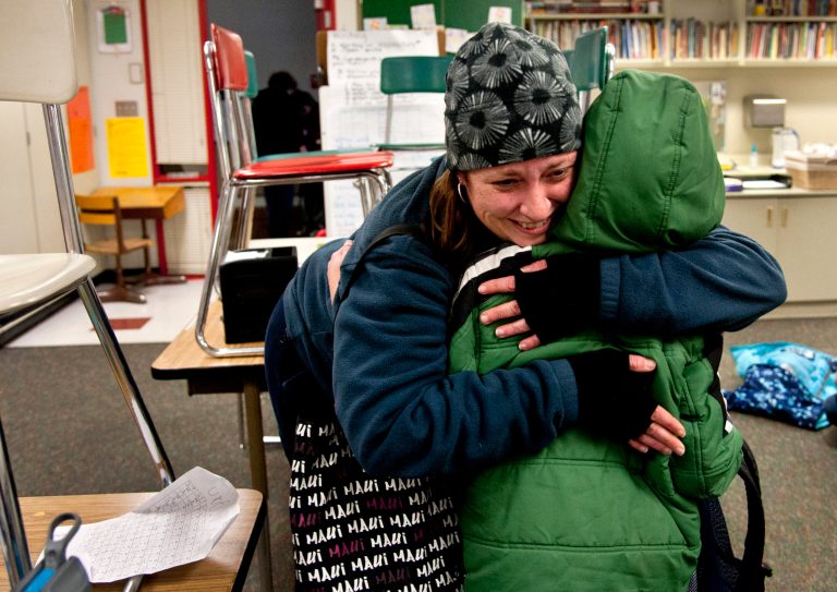   After watching TV news reports of the school shooting in Connecticut, Alicia Combo tightly hugs her son Morgan Askins at the close of school, Dec. 14, 2012, at Garfield Elementary in Spokane, Wash. A man killed his mother at their home and then opened fire Friday inside the elementary school where she taught, massacring 26 people, including 20 children, as youngsters cowered in fear to the sound of gunshots reverberating through the building and screams echoing over the intercom. (AP Photo/Spokesman Review, Dan Pelle)  