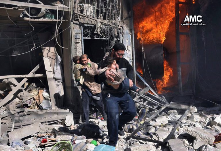 In this photo provided by the anti-government activist group Aleppo Media Center, Syrian men help survivors out of a destroyed building after a Syrian forces warplane's attack in Aleppo, Saturday, Feb. 8, 2014. (AP Photo/Aleppo Media Center AMC)