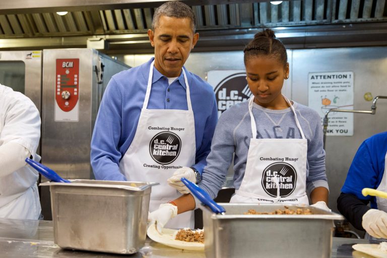 President Barack Obama and his daughter Sasha, right, make burritos at DC Central Kitchen as part of a service project in honor of Martin Luther King, Jr. Day,  Monday, Jan. 20, 2014, in Washington. Also helping were first lady Michelle Obama and daughter Malia Obama. (AP Photo/Jacquelyn Martin)