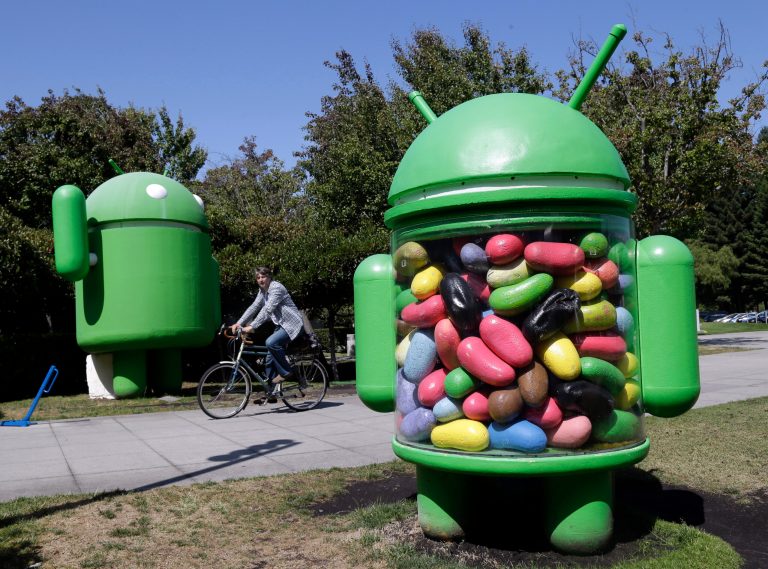 In this June 5, 2014 photo, a man rides a bike through the Google campus in Mountain View, Calif. Google reports quarterly financial results on Thursday, July 17, 2014. (AP Photo/Marcio Jose Sanchez)