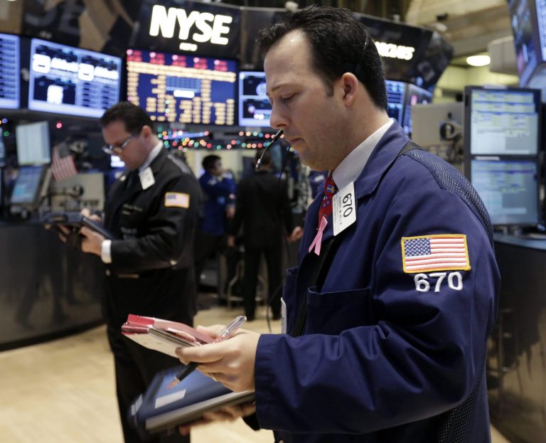   In this Friday, Dec. 14, 2012, photo, trader Robert Vella, right, works on the floor of the New York Stock Exchange. Stocks edged higher on Wall Street amid optimism that the lawmakers in Washington are closing in on a budget deal that will stop the U.S. going over the âfiscal cliff.â (AP Photo/Richard Drew)  