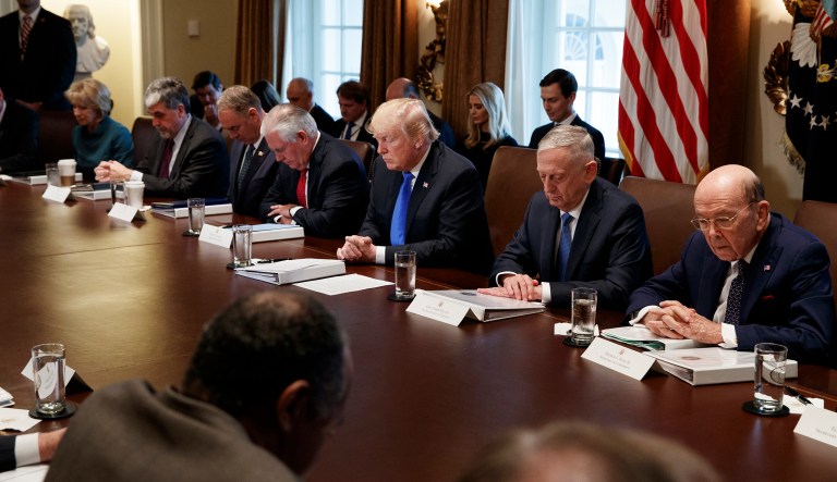 President Trump asked Ben Carson, a former neurosurgeon and presidential candidate, to give the prayer after highlighting the bill's repeal of Obamacare's individual mandate and its permission for oil drilling in a northern Alaska wildlife refuge. (AP Photo/Evan Vucci)