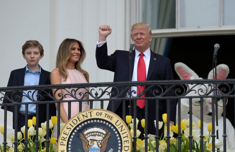 President Donald Trump, with first lady Melania Trump and their son Barron Trump, gestures while speaking from the Truman Balcony of the White House in Washington, Monday, April,17, 2017, during the annual White House Easter Egg Roll on the South Lawn. (AP Photo/Susan Walsh)