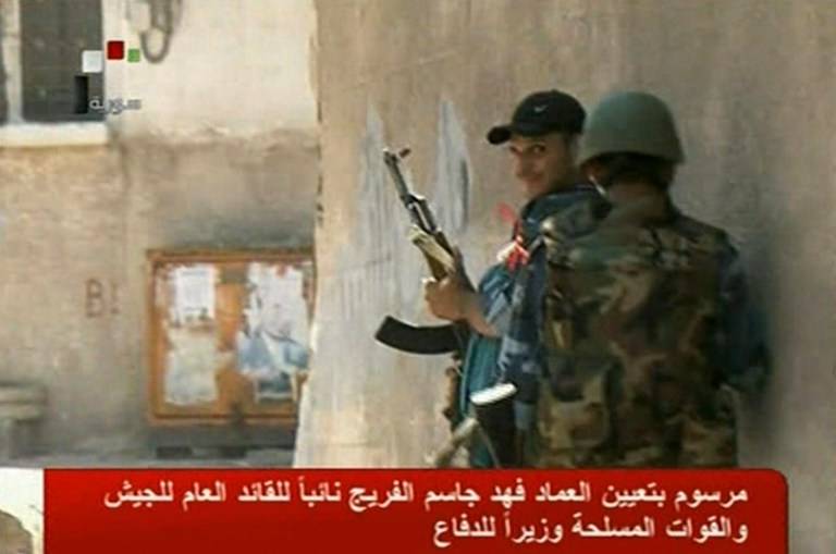 This image made from Syrian State TV video purports to show Syrian troops fighting against Syrian rebels in the Al-Midan area of Damascus, Syria on Wednesday, July 18, 2012. A bomb ripped through a high-level security meeting Wednesday in Damascus, killing three top regime officials, including President Bashar Assad's brother-in-law, in the harshest blow to Syria's ruling family dynasty and the rebels' boldest attack in the country's civil war. (AP Photo/Syrian State TV via AP video)