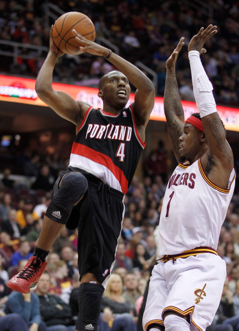   Portland Trail Blazers' Nolan Smith (4) shoots over Cleveland Cavaliers' Daniel Gibson (1) in the first quarter of an NBA basketball game Saturday, Dec. 1, 2012, in Cleveland. (AP Photo/Tony Dejak)  