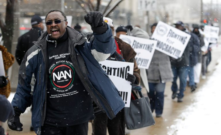 Sylvester Davis, from Detroit Mich., protests outside the offices of JonesDay Monday, March 25, 2013, in Cleveland. Detroit's new emergency manager, Kevyn Orr, said Monday he would offer a 