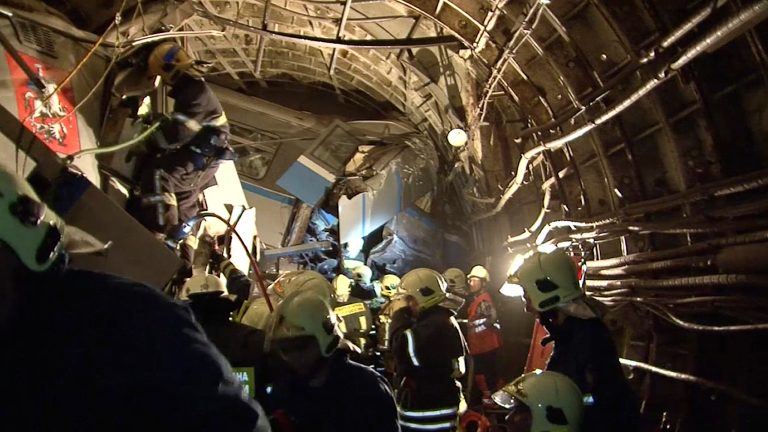 In this frame grab provided by the Russian Ministry for Emergency Situations shows frame grab from a video showing rescue teams working inside the tunnel where several cars of the wrecked train look almost coiled, occupying the entire space of the tunnel of Moscow subway in Moscow, Russia, on Tuesday, July 15, 2014. Workers were seen trying to force open the mangled doors of the car where dead bodies are supposed to be. A rush-hour subway train derailed in Moscow Tuesday, killing about a dozen people and injuring at least 150, emergency officials said. Several cars left the track in the tunnel after a power surge triggered an alarm, which caused the train to stop abruptly. (AP Photo/Russian Emergency Situation Ministry)
