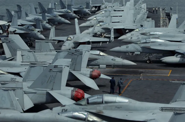 Crew members stand on the flight deck of Aircraft Carrier USS George Washington whilst at anchor in Busan port on July 11, 2014 in Busan, South Korea. (Photo by Chung Sung-Jun/Getty images)