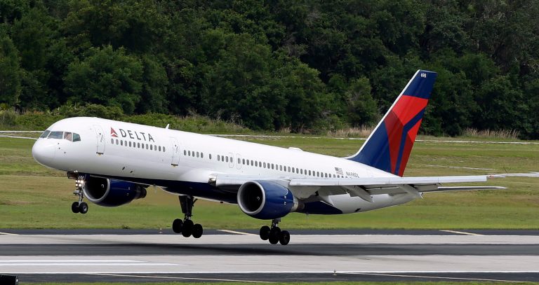 In this May 15, 2014 photo, a Delta Air Lines Boeing 757-232 lands at Tampa International Airport in Tampa , Fla. Delta reports quarterly financial results on Wednesday, July 23, 2014. (AP Photo/Chris O'Meara)