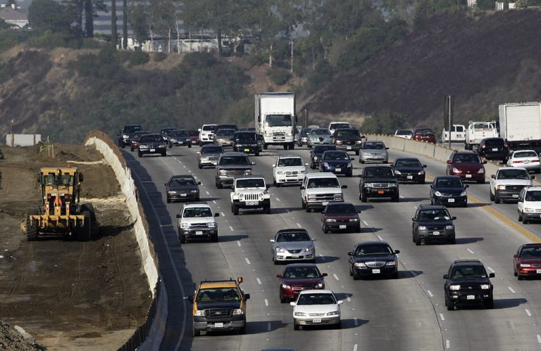 This Oct. 2010 file photo shows CalTrans, left, working along the 405 Freeway in Los Angeles. A new report commissioned by California's top transportation officials concludes that the state department in charge of highway planning and construction needs a major overhaul. The report authors say that the California Department of Transportation, known as Caltrans, is stuck in the past.