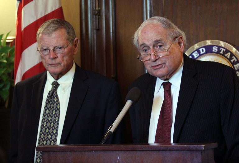 Senate Armed Services Committee Chairman, Sen. Carl Levin, D-Mich., right, and Sen. Jim Inhofe, R-OK,  talk to reporters about cyberattacks from China, Wednesday, Sept. 17, 2014 on Capitol Hill in Washington.  China's military hacked into computer networks of civilian transportation companies hired by the Pentagon at least nine times, breaking into computers aboard a commercial ship, targeting logistics companies and uploading malicious software onto an airline's computers, Senate investigators said Wednesday.  (AP Photo/Lauren Victoria Burke)
