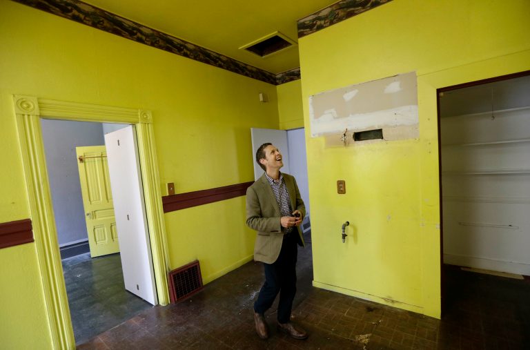 FILE - In this July 30, 2014 file photo, George Limperis, a realtor with Paragon Real Estate Group, walks through the kitchen of a property in the Noe Valley neighborhood in San Francisco. On Thursday, Aug. 21, 2014, the National Association of Realtors is scheduled to report on existing-home sales in July 2014. (AP Photo/Jeff Chiu, File)