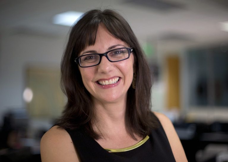 In this June 24, 2014 photo, newly named Associated Press business editor Lisa Gibbs poses for a photo in Miami. Gibbs, a former executive business editor at the Miami Herald and a senior writer at Money, will oversee more than 65 business reporters and editors worldwide. She will be based in New York and start the job in late August. (AP Photo/J Pat Carter)