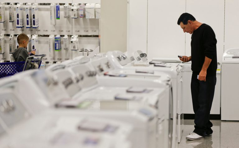 FILE - In this Friday, Nov. 23, 2012, file photo, a man examines a row of washers and dryers while shopping at a Sears store in Henderson, Nev. Consumer spending has recovered at a much slower pace in states with big housing busts, a stark illustration of how the housing downturn has weighed on the economy years after the recession. Spending in Nevada rose just 3.5 percent in the first three years after the recession ended, the weakest of any state and far below the national average of 10.7 percent, according to a new annual government report. (AP Photo/Julie Jacobson, File)