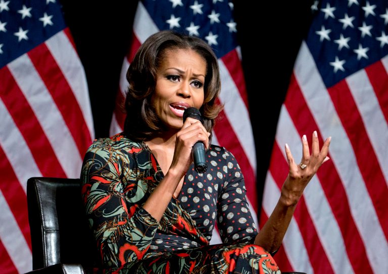 First lady Michelle Obama gestures as he speaks to students about committing to education to create a better future for themselves and their country, Tuesday, Nov. 12, 2013, at Bell Multicultural High School in Washington. Edging into a broader policy role, Michelle Obama is joining President Barack Obama's efforts to get the United States on track to have the highest percentage of college graduates by 2020.  (AP Photo/Carolyn Kaster)
