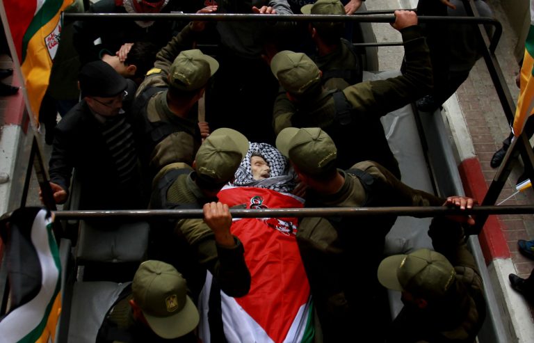 Palestinian police escort the body of Maysara Abu Hamdiyeh during his funeral in the West Bank city of Hebron, Thursday, April 4, 2013. Demonstrations first erupted across the West Bank on Tuesday over the death of a Palestinian prisoner who died from cancer. The 64-year-old prisoner, Hamdiyeh, was serving a life sentence for a 2002 foiled bombing of a busy Jerusalem cafe. After Abu Hamdiyeh died, the Palestinians blamed Israel for the death, saying he was not given proper medical care. Israel says the prisoner was treated by specialist doctors in hospital. (AP Photo/Nasser Shiyoukhi)