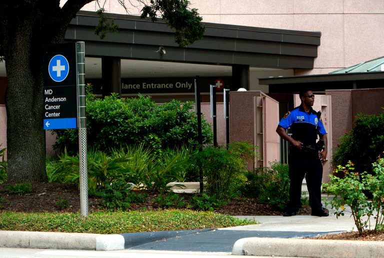   A police officer stands in front of the MD Anderson Cancer Center where Vice President Joe Biden reportedly entered, Tuesday, Aug. 20, 2013, in Houston. Biden entered the hospital to support his son who sought medical attention at the hospital. (AP Photo/Houston Chronicle, Cody Duty) Mandatory Credit  