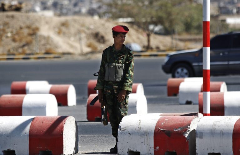   A Yemeni soldier stands guard at a street leading to the presidential palace in Sanaa, Yemen, Tuesday, Dec. 25, 2012. Gunmen on motorbikes assassinated two Yemeni army officers in the country's capital Tuesday while clashes between the military and tribal fighters loyal to al-Qaida in a northeastern province killed three soldiers and several tribesmen, officials said. (AP Photo/Hani Mohammed)  