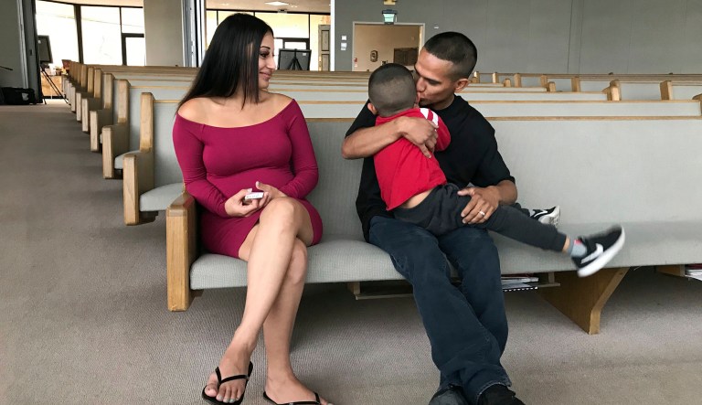 Jesus Berrones (pictured right, seated) holds his five-year-old son, Jayden, as his wife, Sonia, looks on at the Shadow Rock United Church of Christ in Phoenix, where he has sought sanctuary to avoid deportation back to his native Mexico. Jayden was diagnosed with leukemia in 2016 and is undergoing a three-year course of chemotherapy. (AP Photo/Anita Snow)