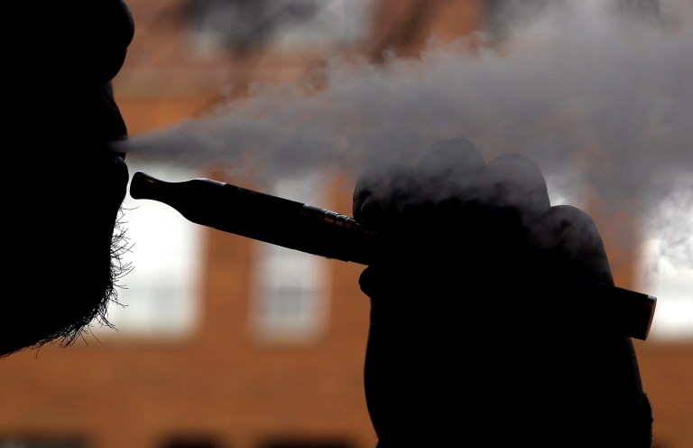 Daryl Cura demonstrates an e-cigarette at Vape store in Chicago, Wednesday, April 23, 2014. The federal government wants to ban sales of electronic cigarettes to minors and require approval for new products and health warning labels under regulations being proposed by the Food and Drug Administration. (AP Photo/Nam Y. Huh)
