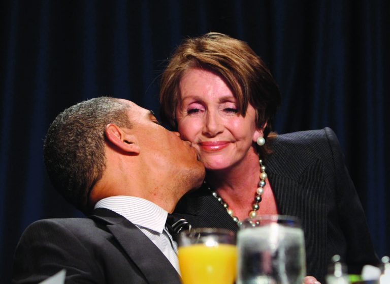House Minority Leader Rep. Nancy Pelosi  receives a kiss from President Obama at the National Prayer Breakfast last February. (Photo by Chris Kleponis-Pool/Getty Images)