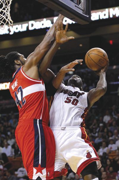 Alan Diaz/AP
Nene helped the Wizards beat the Heat on Saturday--scoring the game-winning layup--in his second game back after missing 10 with plantar fasciitis.
