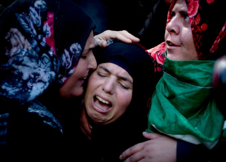 Palestinian Fatema Masalmeh, center, the wife of slain Udai Masalmeh, 24, mourns during his funeral at the family house in the West Bank village of Beit Awa, Hebron, Wednesday, Oct. 21, 2015. The 24 year old Palestinian was fatally shot near the village of Beit Awa after lightly injuring an Israeli army officer with a knife, according to a statement from the military. (AP Photo/Nasser Nasser)