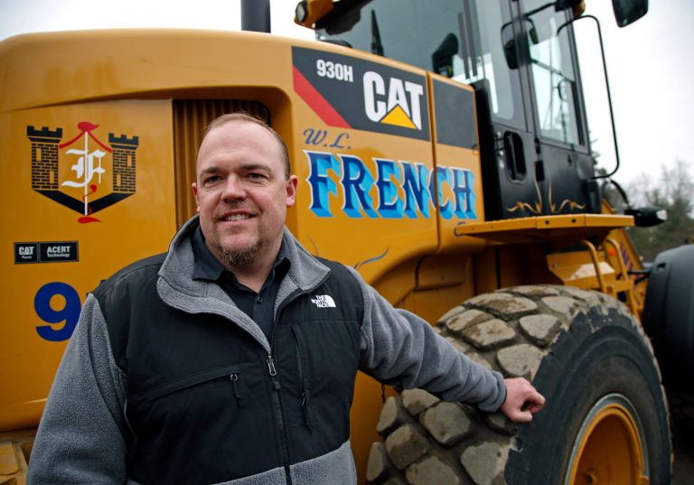 Bill French Jr., owner of W. L. French Excavating Corporation, stands on his company property in Billerica, Mass., Monday, April 7, 2014. Behind him is equipment he bought with small business tax breaks before they expired at the end of last year. He spent $2 million on equipment, and estimates the deductions saved him $1.1 million. French has put more purchases on hold, hoping the Senate Finance Committee will vote to revive the tax breaks. (AP Photo/Elise Amendola)