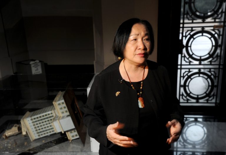 FILE - In this Jan. 29, 2012, file photo, Oakland Mayor Jean Quan surveys damage to City Hall in Oakland, Calif., following an Occupy Oakland. Oakland police tell the San Francisco Chronicle that Quan was involved in a minor traffic collision at a West Oakland intersection Sunday, June 8, 2014, but wasn't hurt. (AP Photo/Noah Berger, File)