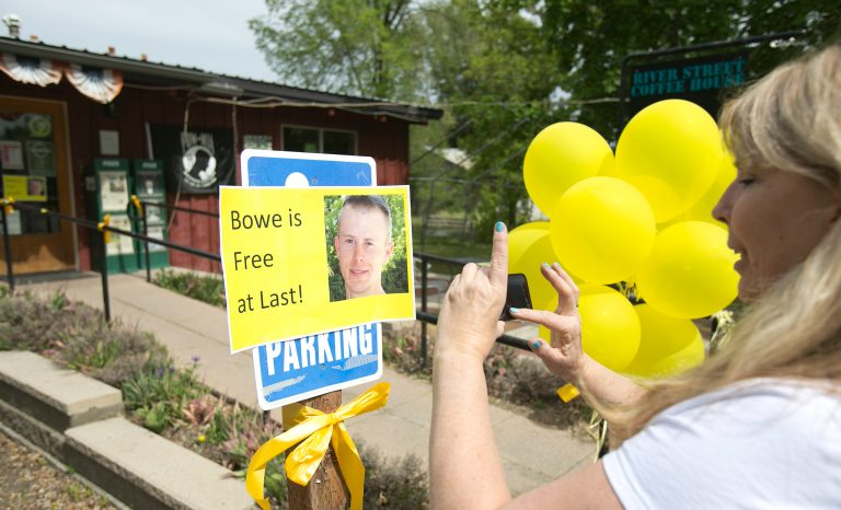 Diane Walker takes a picture of a sign celebrating U.S. Army Sgt. Bowe Bergdahl's release in front of Zaney's coffee shop in Hailey, Idaho. (AP/The Idaho Statesman, Kyle Green)