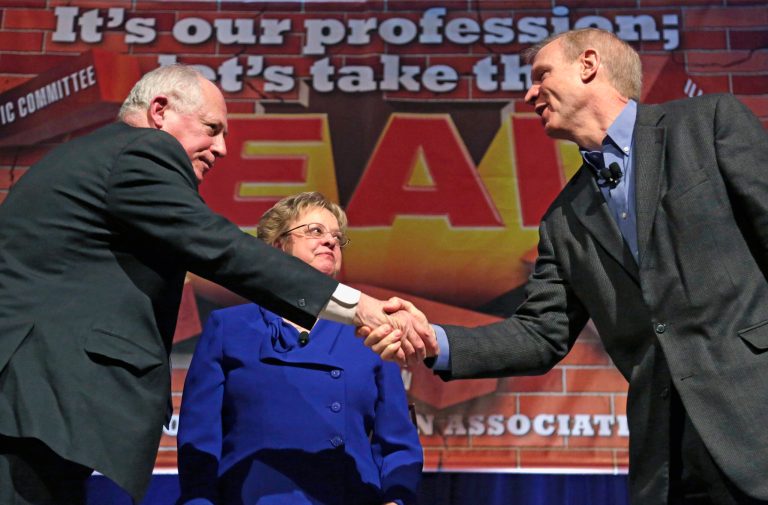 FILE - In this April 11, 2014 file photo, Illinois Gov. Pat Quinn, left, and his Republican rival, businessman Bruce Rauner, shake hands after they appeared together at the annual meeting of the Illinois Education Association in Chicago. Illinois has seen a roughly 30 percent increase in the number of TV ads and the money spent to air them this election cycle compared to four years ago, according to an analysis by the non-partisan Center for Public Integrity. That jump has been fueled by the neck-and-neck race between Rauner and Quinn. (AP Photo/M. Spencer Green, File)