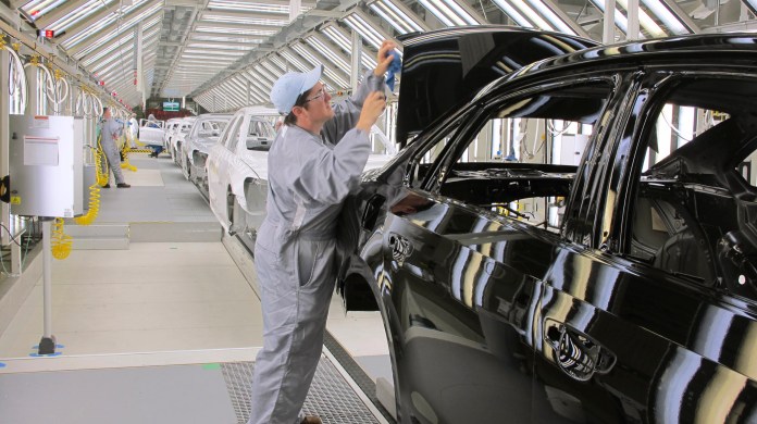 In a May 17, 2011 photo, Volkswagen employee Trina Galanto works on paint finish on a 2012 Passat at the automaker's plant in Chattanooga, Tenn. (AP File)