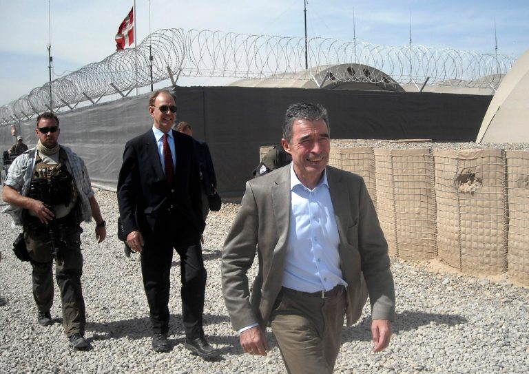 NATO Secretary-General Anders Fogh Rasmussen, front, tours with Maurits Jochems, center, NATO ambassador to Afghanistan, the ISAF headquarters Task Force Helmand, Tuesday, March 5, 2013. NATO's chief is embracing a proposal to keep 352,000 Afghans in uniform through 2018 -- about 122,000 more than originally planned. (AP Photo/Kimberly Dozier)