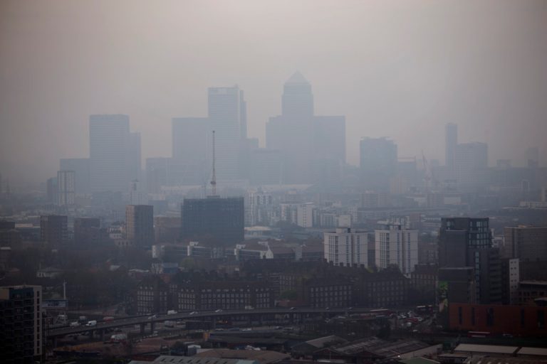 The skyscrapers of the Canary Wharf business district in London are shrouded in smog, as seen from a viewing gallery on the Orbit sculpture in the Queen Elizabeth Olympic Park during an tour of the park organized for the media, Wednesday, April 2, 2014. British authorities have warned people with heart or lung conditions to avoid exertion as a combination of industrial pollution and Sahara dust blankets the country in smog.  The environment department said Wednesday's air pollution level could reach the top rung on its 10-point scale. (AP Photo/Matt Dunham)