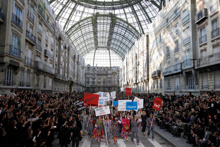 Models stage a demonstration as part of Chanel's Spring/Summer 2015 ready-to-wear fashion collection presented in Paris, France, Tuesday, Sept. 30, 2014. (AP Photo/Francois Mori)