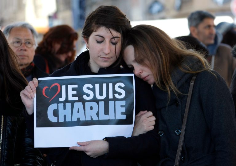 People pay tribute to the Charlie Hebdo victims, in Marseille, southern France, after masked gunmen stormed the offices of the satirical newspaper and killed 12 people. (AP Photo/Claude Paris)